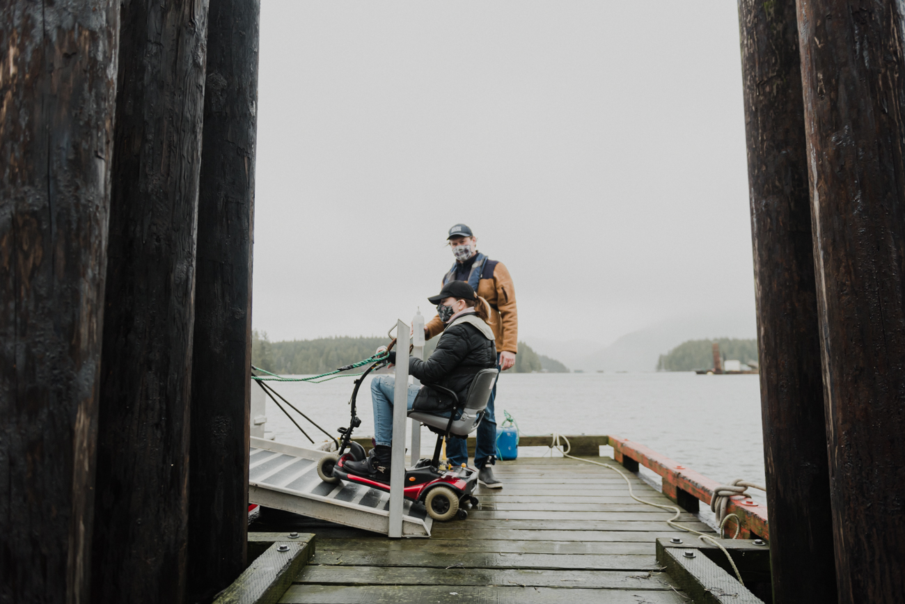 Woman with wheelchair boarding a boat